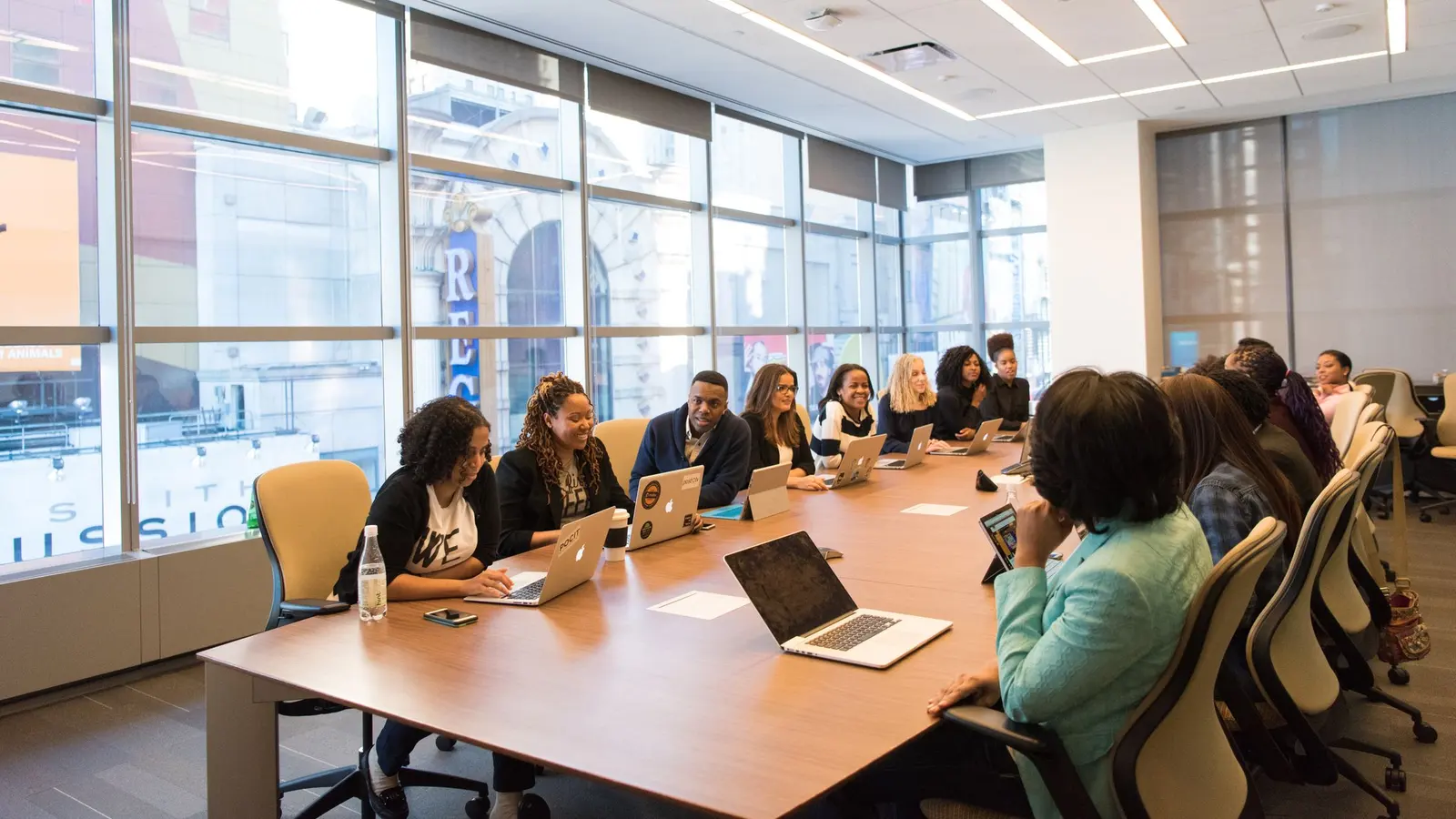A team working on laptops around a conference table