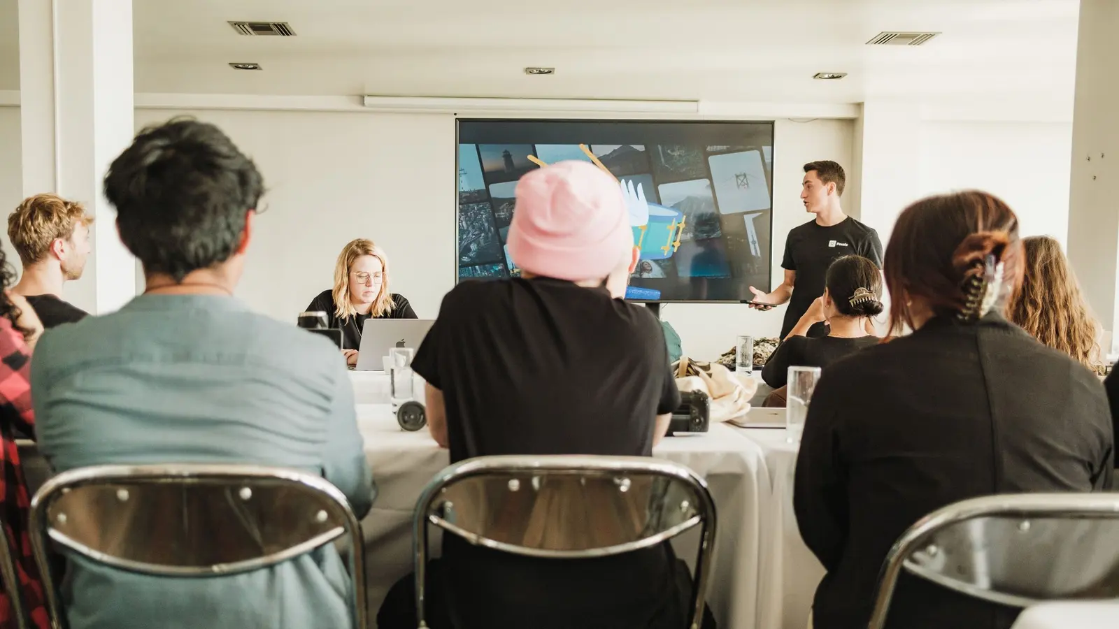 A team listening to a presentation in a conference room