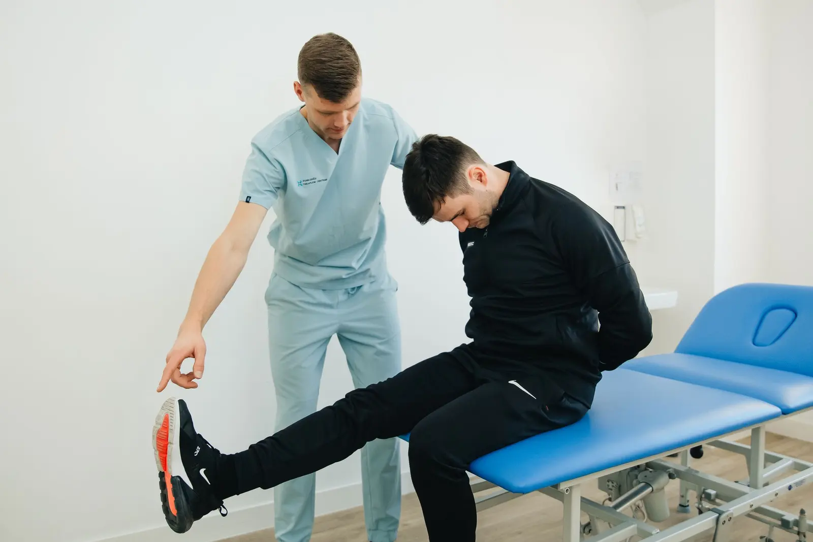 Physical therapist guiding a patient through an exercise. Stock photograph, not an Engaged Headhunters client or placement.
